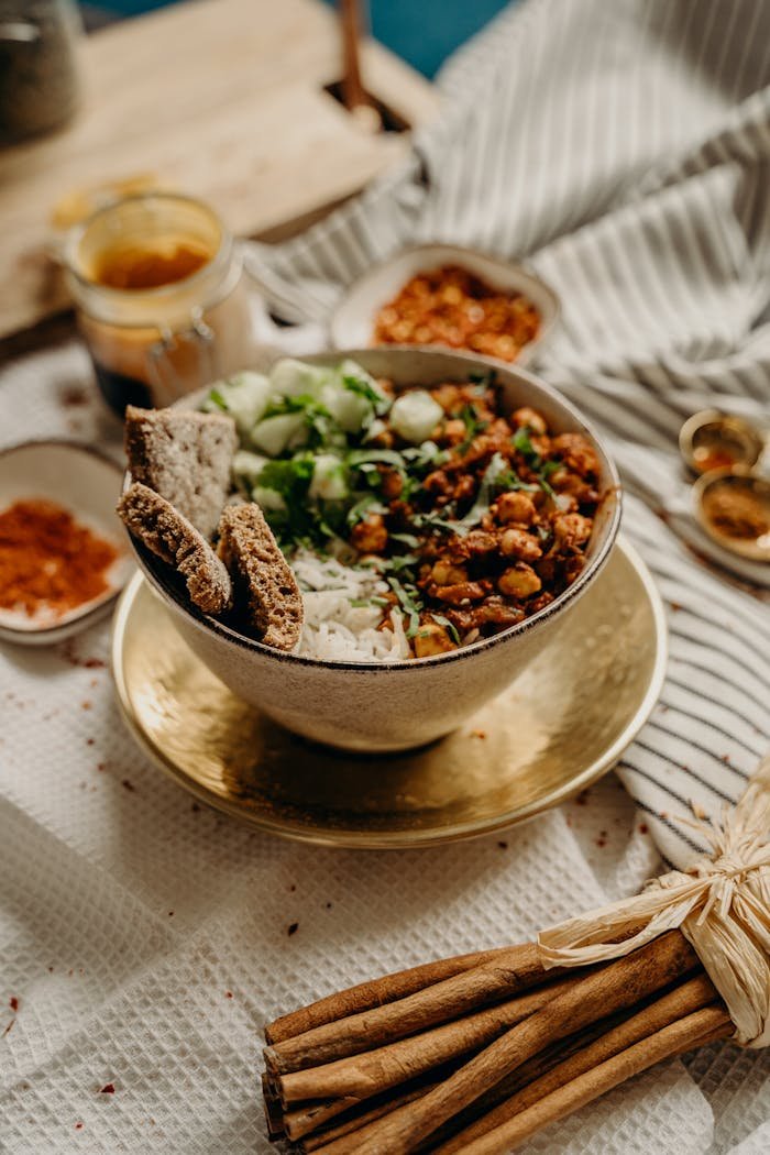 A delicious, healthy vegan bowl featuring chickpeas, rice, cucumbers, and spices. Perfect for a nutritious meal.